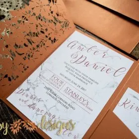 laser cut metallic copper invitation pocket with marble textured invite and rsvp inside
