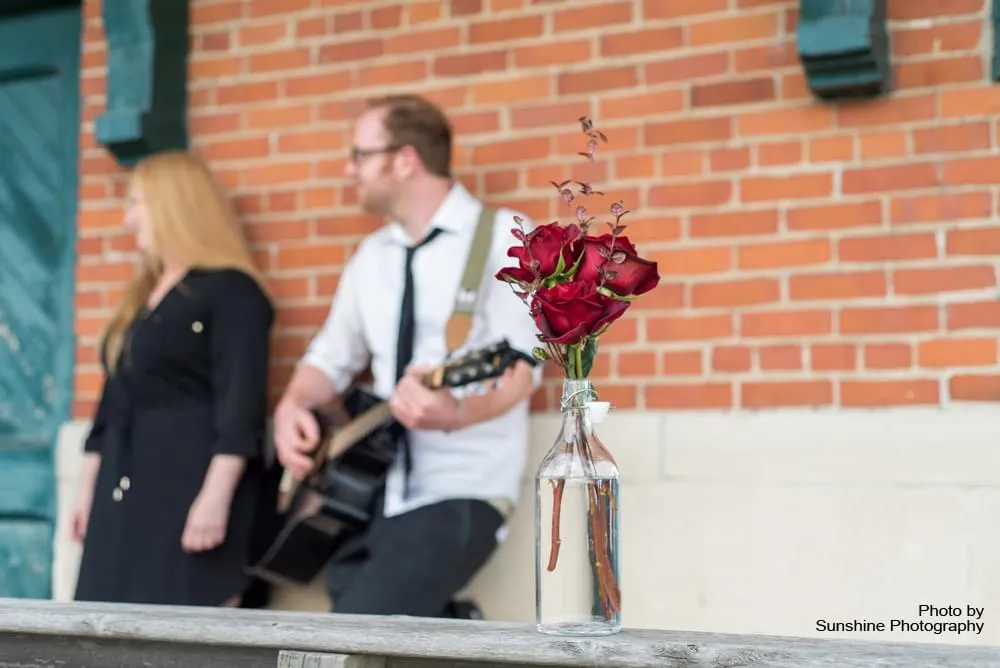 Entertainers with flowers in bottle, in focus