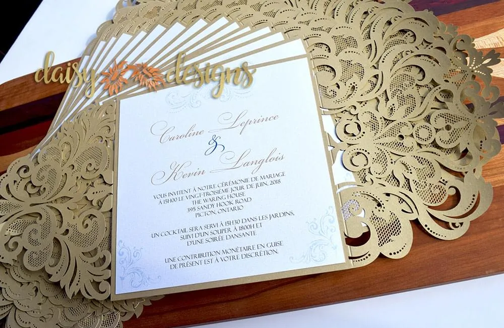 Gold Laser Cut invites displayed in a fan shape