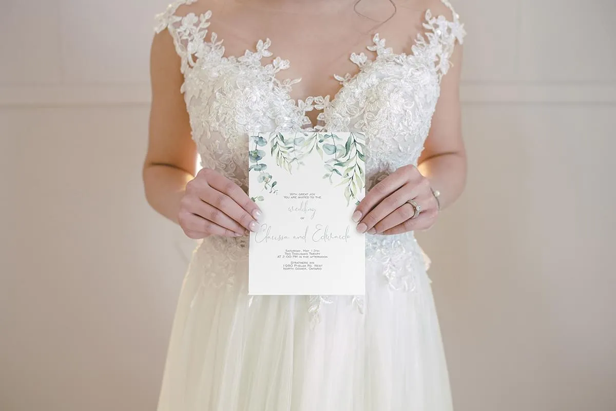 Watercolour Eucalyptus invite held by bride